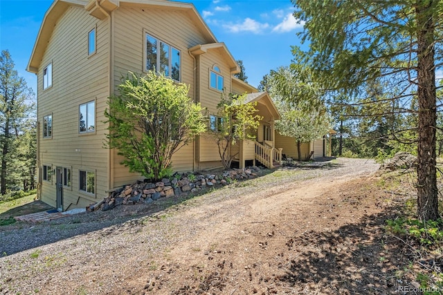 6252 King Dr, Evergreen, CO 80439 - view of home's exterior with entry steps and dirt driveway