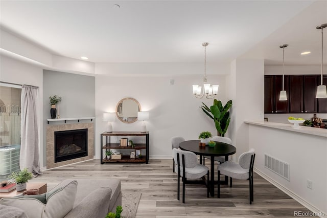 332 N Parkside Dr Unit C, Longmont, CO 80501 - living room with light wood-style floors, recessed lighting, a chandelier, and a tile fireplace
