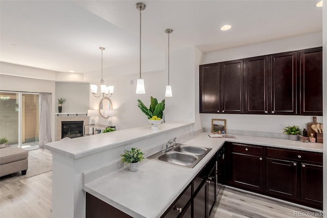 332 N Parkside Dr Unit C, Longmont, CO 80501 - kitchen with light countertops, light wood-style flooring, open floor plan, recessed lighting, and a peninsula