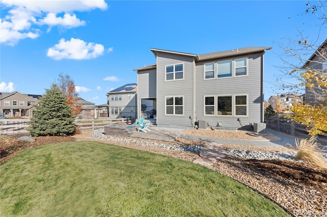 rear view of house featuring central AC, a patio area, and a lawn