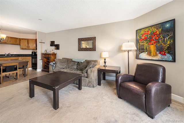 carpeted living room with sink, a textured ceiling, and an inviting chandelier