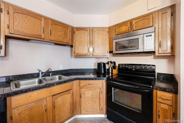 kitchen featuring light tile patterned flooring, sink, and black range with electric cooktop