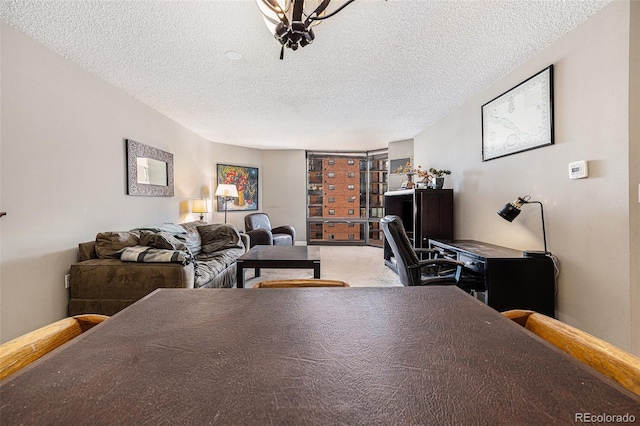 carpeted home office with a textured ceiling