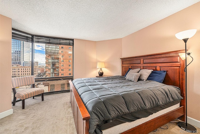 bedroom featuring a textured ceiling and light carpet