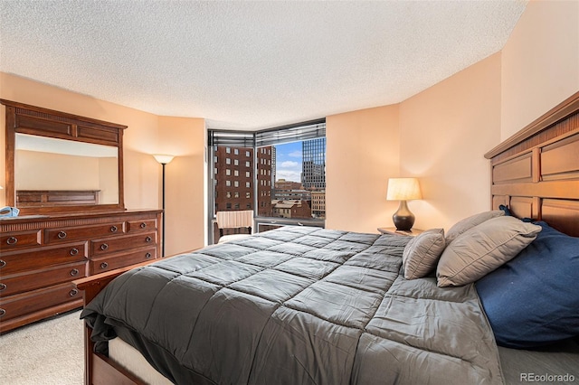 carpeted bedroom featuring a textured ceiling