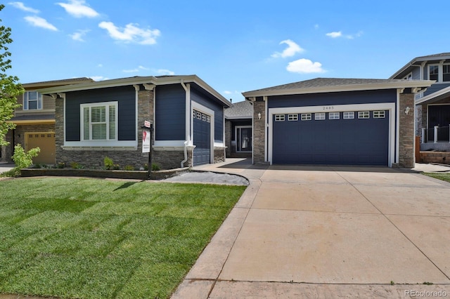 2485 Vale Way, Erie, CO 80516 - view of front of house with stone siding, driveway, a front yard, and an attached garage