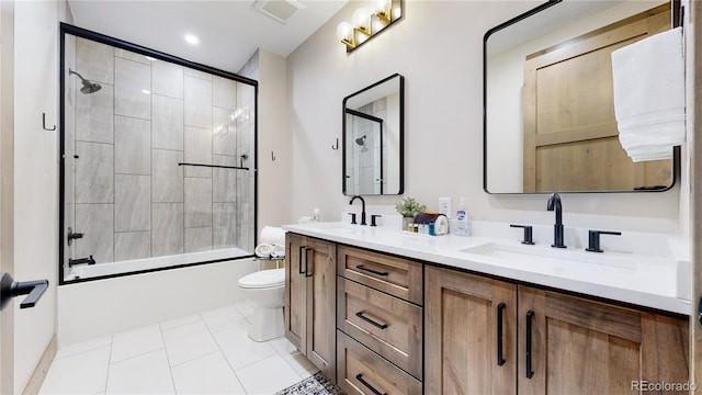 full bathroom with tile patterned flooring, vanity, toilet, and shower / bath combination with glass door