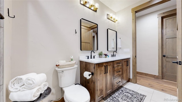 bathroom featuring tile patterned flooring, vanity, and toilet