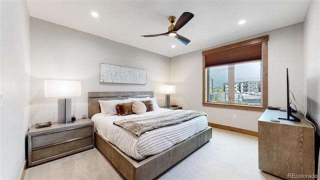 bedroom featuring light colored carpet and ceiling fan