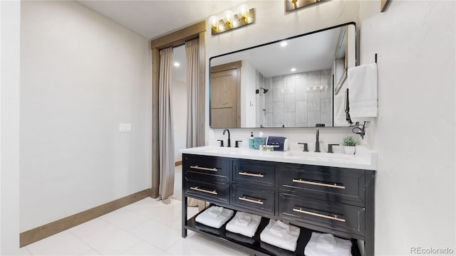 bathroom featuring tile patterned flooring, a shower, and vanity