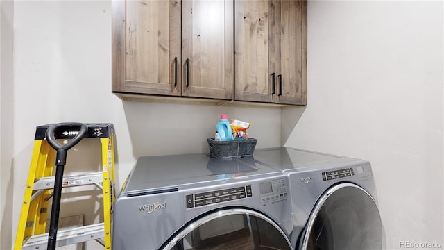 laundry area featuring cabinets and washer and clothes dryer