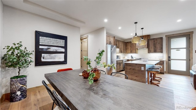 dining space with light hardwood / wood-style flooring