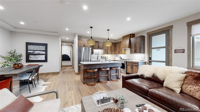 living room with light hardwood / wood-style floors and sink