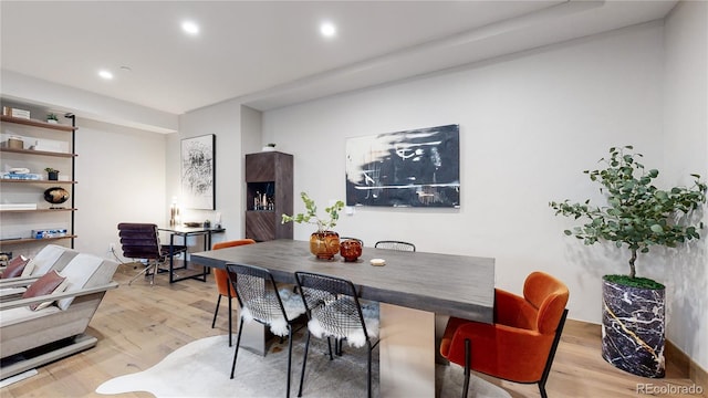 dining room with light wood-style floors and recessed lighting