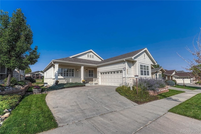 view of front facade with concrete driveway, covered porch, a garage, and stone siding