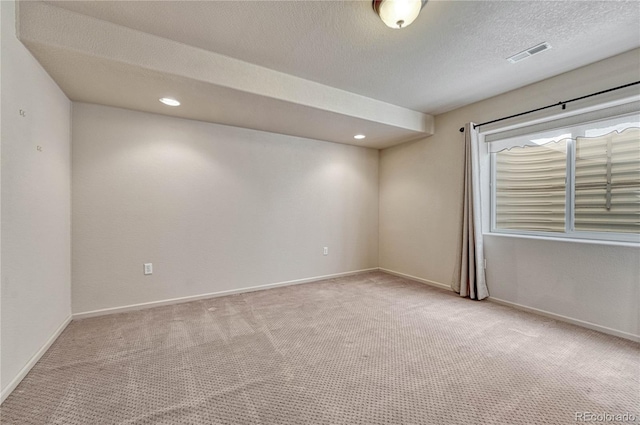 unfurnished room featuring visible vents, baseboards, carpet flooring, recessed lighting, and a textured ceiling