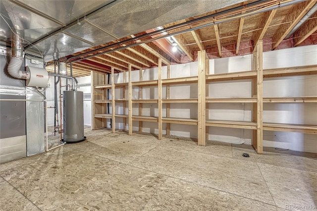 unfinished basement featuring gas water heater and heating unit