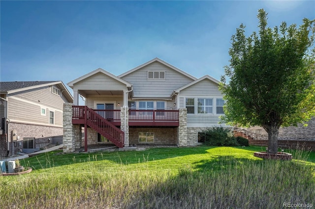 back of property featuring stairway, stone siding, a deck, central air condition unit, and a lawn