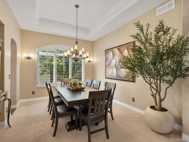 6266 W Prentice Ave, Littleton, CO 80123 - dining space with visible vents, an inviting chandelier, light carpet, arched walkways, and a tray ceiling