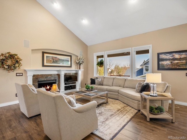 6266 W Prentice Ave, Littleton, CO 80123 - living room featuring a stone fireplace, baseboards, high vaulted ceiling, and dark wood finished floors