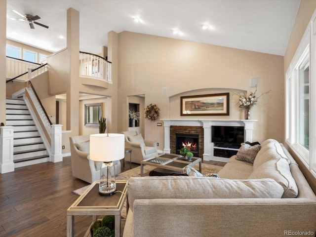 6266 W Prentice Ave, Littleton, CO 80123 - living area featuring a wealth of natural light, stairway, a warm lit fireplace, and wood finished floors