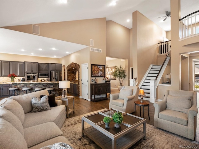 6266 W Prentice Ave, Littleton, CO 80123 - living area with high vaulted ceiling, visible vents, dark wood finished floors, stairway, and ceiling fan