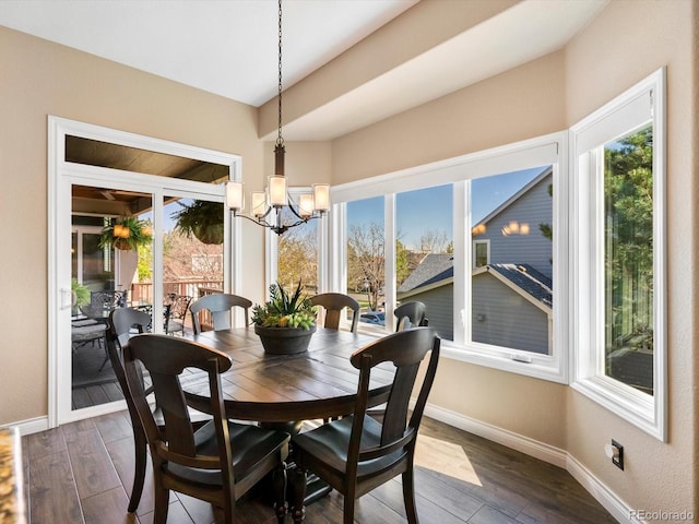 6266 W Prentice Ave, Littleton, CO 80123 - dining area with dark wood-type flooring, baseboards, a healthy amount of sunlight, and a notable chandelier