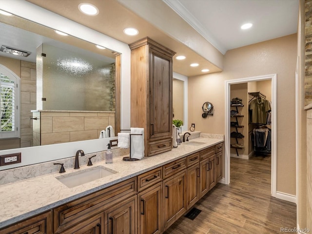 6266 W Prentice Ave, Littleton, CO 80123 - full bathroom featuring double vanity, wood finished floors, ornamental molding, and a sink