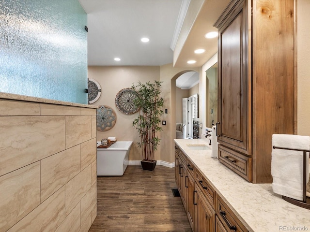 6266 W Prentice Ave, Littleton, CO 80123 - bathroom with recessed lighting, baseboards, vanity, a freestanding bath, and wood finished floors