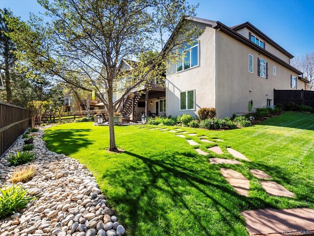 6266 W Prentice Ave, Littleton, CO 80123 - view of yard featuring stairs, a wooden deck, and fence