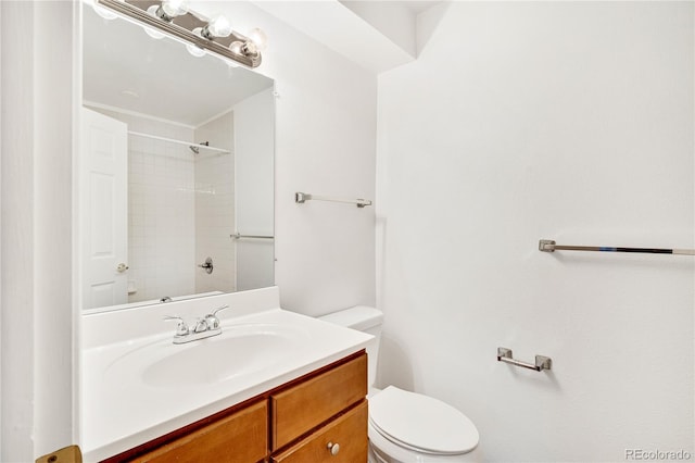 bathroom with vanity, toilet, and walk in shower