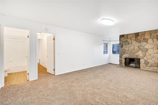 unfurnished living room featuring carpet floors and a fireplace