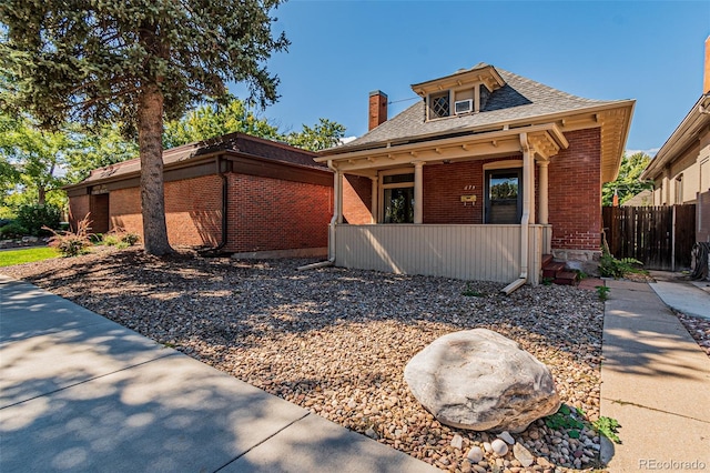 873 S Logan St, Denver, CO 80209 - bungalow-style house with brick siding, covered porch, roof with shingles, and a chimney