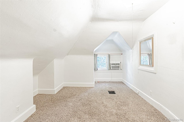 873 S Logan St, Denver, CO 80209 - additional living space with vaulted ceiling, cooling unit, and carpet floors