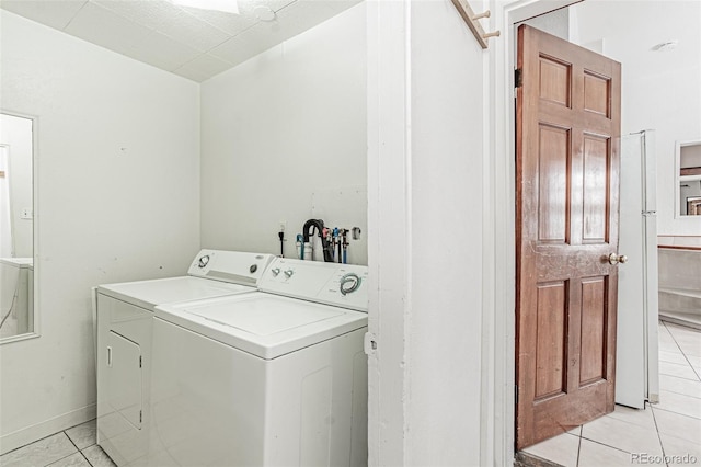 873 S Logan St, Denver, CO 80209 - laundry room with light tile patterned floors and washer and clothes dryer