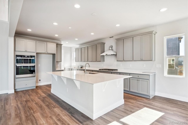 kitchen with hardwood / wood-style floors, gray cabinets, and sink