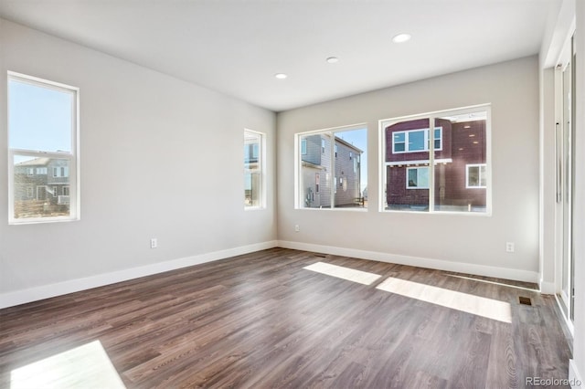 unfurnished room with dark hardwood / wood-style floors