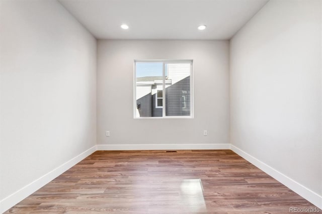 unfurnished room with light wood-type flooring