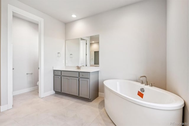 bathroom featuring vanity, toilet, and a tub