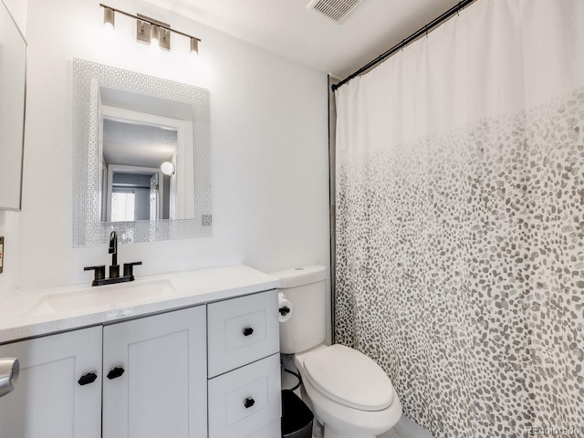 2575 S Syracuse Way Unit K201, Denver, CO 80231 - bathroom featuring toilet, vanity, and a shower with curtain