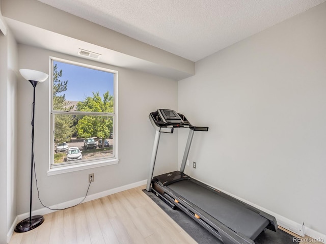 2575 S Syracuse Way Unit K201, Denver, CO 80231 - exercise room with wood finished floors, baseboards, and a textured ceiling