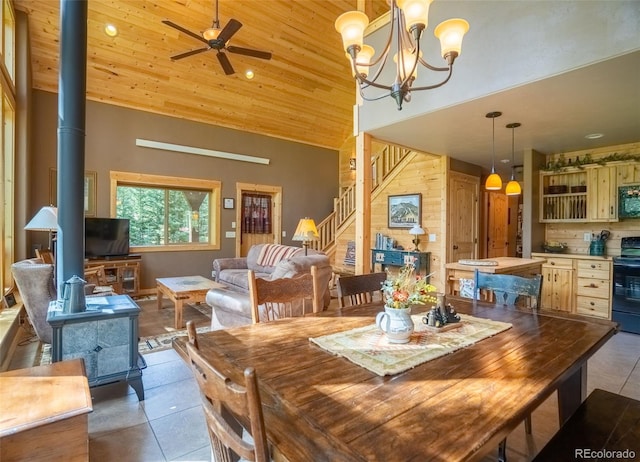 25879 County Road 162e, Nathrop, CO 81236 - dining area featuring a wood stove, high vaulted ceiling, tile patterned floors, stairway, and a ceiling fan