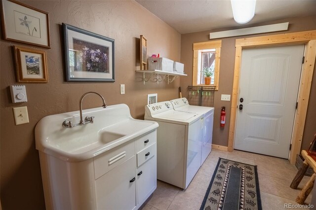 25879 County Road 162e, Nathrop, CO 81236 - washroom featuring washing machine and dryer, cabinet space, light tile patterned flooring, and baseboards