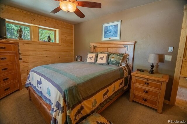 25879 County Road 162e, Nathrop, CO 81236 - bedroom featuring wood walls, light colored carpet, and ceiling fan