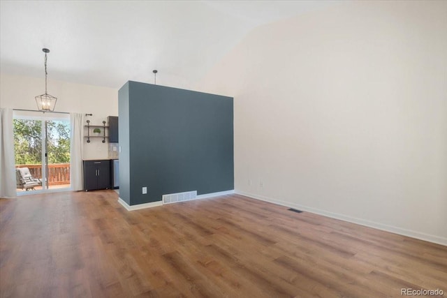 6318 Newton Ct, Arvada, CO 80003 - spare room featuring wood finished floors, high vaulted ceiling, and a chandelier