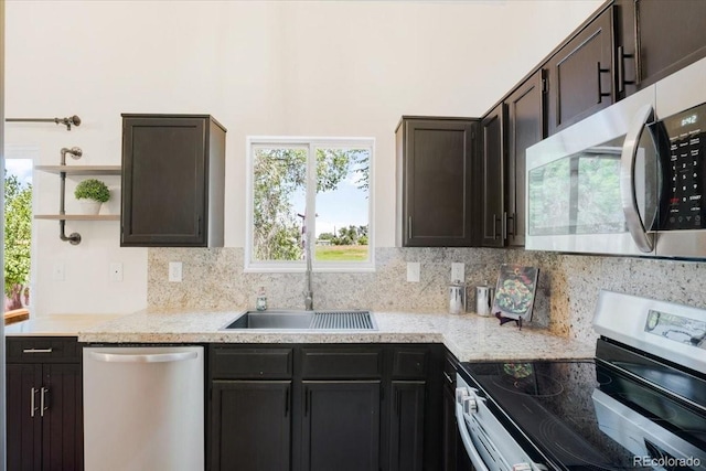 6318 Newton Ct, Arvada, CO 80003 - kitchen featuring appliances with stainless steel finishes, open shelves, backsplash, and dark brown cabinets