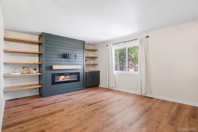 6318 Newton Ct, Arvada, CO 80003 - unfurnished living room featuring a fireplace and light wood-style floors