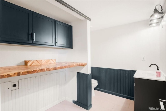 6318 Newton Ct, Arvada, CO 80003 - bathroom with vanity and wainscoting