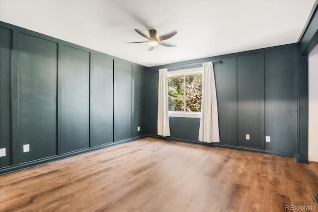 6318 Newton Ct, Arvada, CO 80003 - unfurnished room featuring a decorative wall, ceiling fan, and wood finished floors