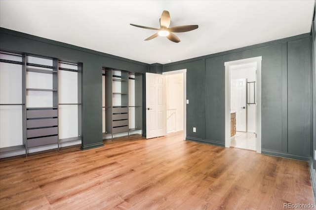 6318 Newton Ct, Arvada, CO 80003 - unfurnished bedroom with light wood finished floors, a decorative wall, connected bathroom, and a ceiling fan